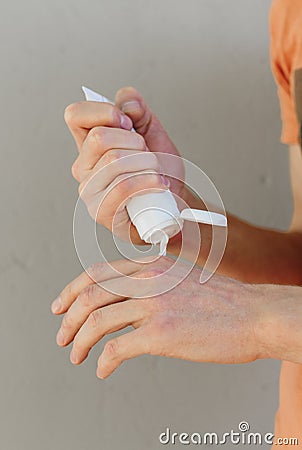 Applying an emollient to dry flaky skin as in the treatment of psoriasis, eczema and other dry skin conditions Stock Photo