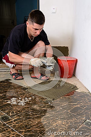 Applying a glue to a spatula by a man Stock Photo