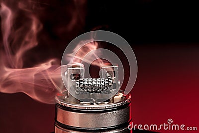 Applying liquid with nicotine in the coils on the RDA Stock Photo