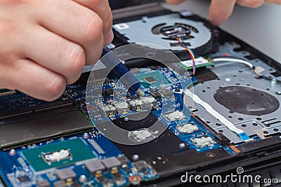 Applying a new thermal paste to the laptop cooling system from a tube Stock Photo
