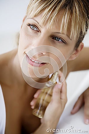 Applying perfume Stock Photo