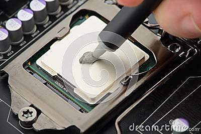 Applying thermal paste to CPU Stock Photo