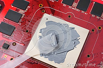 Applying the thermal paste to the GPU card chip for better cooling Stock Photo