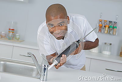 Applying water resistant glue Stock Photo