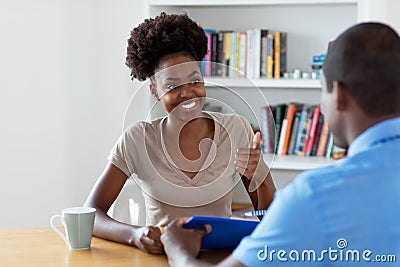 Apprentice and african american buisnessman signing contract Stock Photo