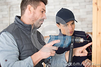 apprentice being graded by drilling wall Stock Photo