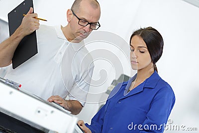 Apprentice checking appliance for repair Stock Photo