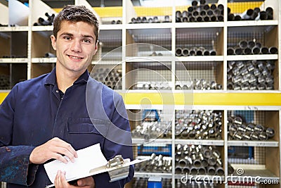 Apprentice Checking Stock Levels In Store Room Stock Photo