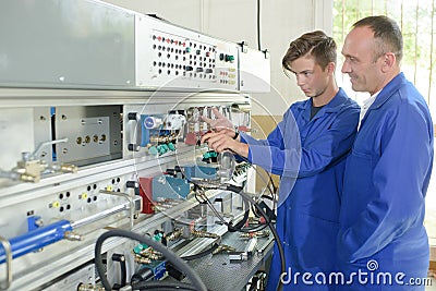 Apprentice electrician and tutor Stock Photo