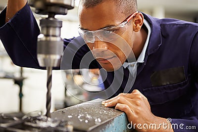Apprentice Engineer Using Milling Machine Stock Photo