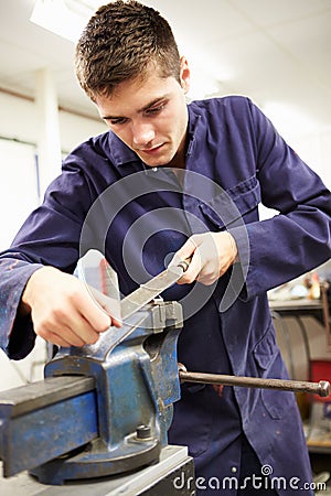 Apprentice Engineer Working On Factory Floor Stock Photo