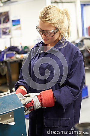 Apprentice Engineer Working On Factory Floor Stock Photo