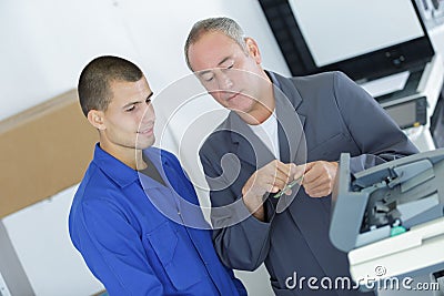 Apprentice technician listening to teacher Stock Photo