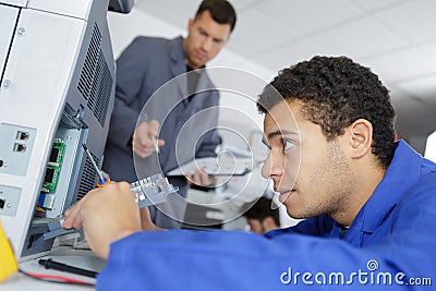 Apprentice technician repairing printer at business place at work Stock Photo