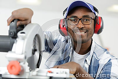 apprentice using circular saw in carpentry workshop Stock Photo