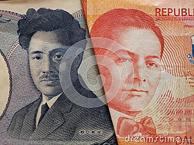 approach to japanese banknote of 1000 yen and Philippine banknote of twenty pesos Stock Photo