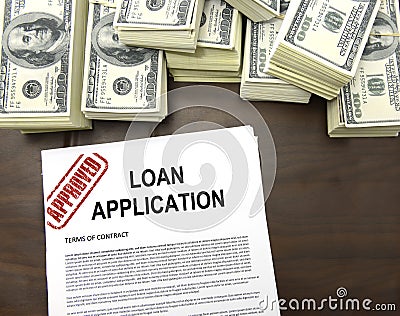 Approved loan application form and dollar bills Stock Photo