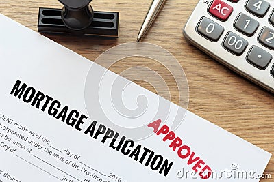 Approved mortgage application form lay down on wooden desk with Stock Photo