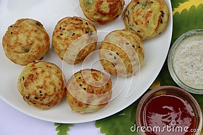 Appum or Appe, Appam or Mixed dal or Rava Appe served with green and red chutney. A Ball shape popular south Indian breakfast dish Stock Photo