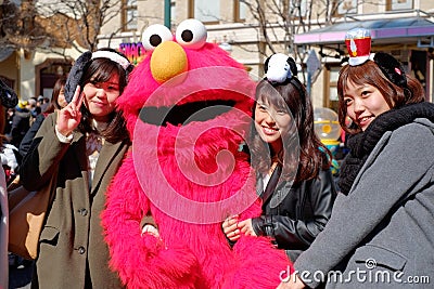 Appy asian girls take shot with Sesame Street Elmo in Universal Studios Japan USJ, Osaka, Japan Editorial Stock Photo