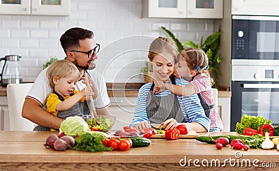 Appy family with child preparing vegetable salad Stock Photo