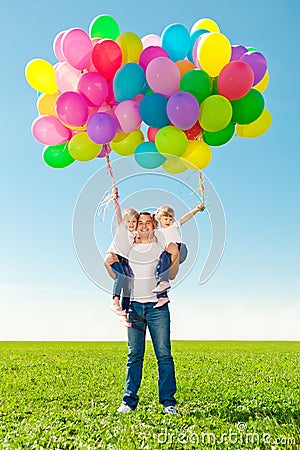 Appy family together in outdoor park at sunny day. Dad and two Stock Photo