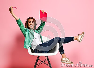 Young woman studying whith notepad in a chair Stock Photo