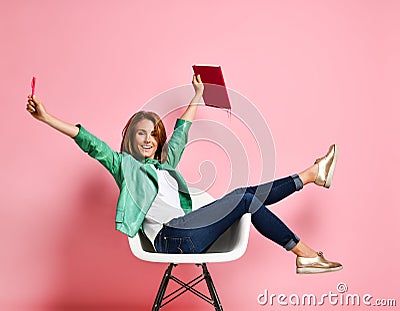 Young woman studying whith notepad in a chair Stock Photo