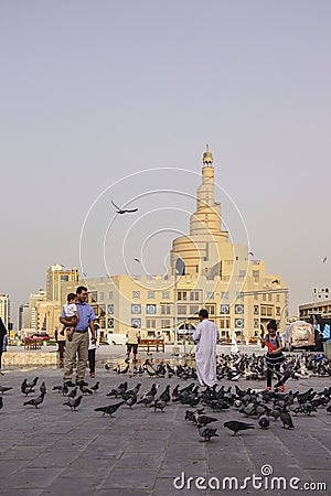 Lots of pigeons and local people in Doha Editorial Stock Photo
