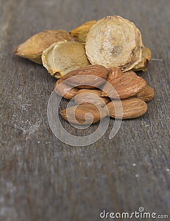 Apricot Kernels and pip on wood Stock Photo