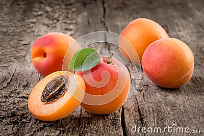 Apricot. Organic fruit with leaf on wooden background Stock Photo