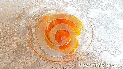 Apricot yellow jam in transparent saucer, photo color Stock Photo