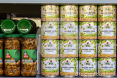 April 22, 2021 Balti Moldova goods on the market shelf. Illustrative editorial. Tin cans with mushrooms and green peas Editorial Stock Photo