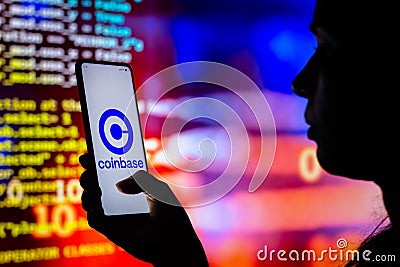 April 12, 2022, Brazil. In this photo illustration, a woman holds a smartphone with the Coinbase logo displayed on the screen Cartoon Illustration