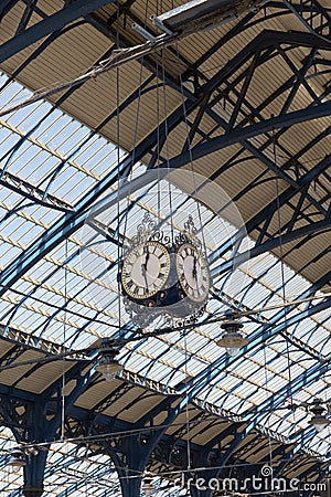 April 2015 - Brighton, England: trainstation at Brighton looking up the roof and clock Editorial Stock Photo