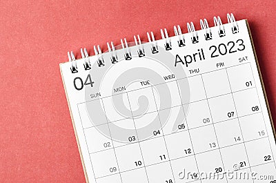 A April 2023 calendar desk for the organizer to plan and reminder isolated on red background Stock Photo