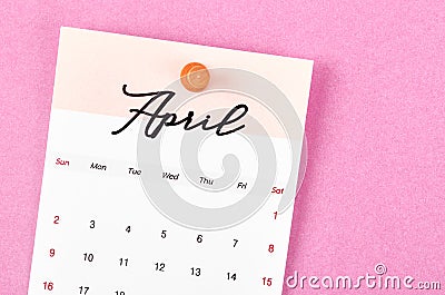 A April 2023 calendar and wooden push pin on pink colour background Stock Photo