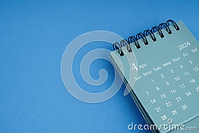 April 2024 desk calendar on blue color background Stock Photo