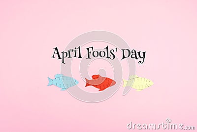 April Fools ` Day celebration background with paper fish and text on pink background. All Fools ` Day, humor, prank, joke concept Stock Photo