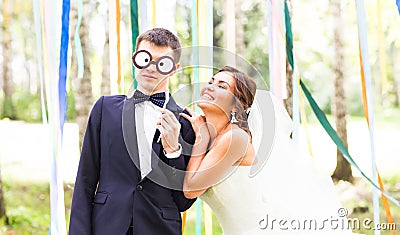 April Fools' Day. Wedding couple have fun with mask. Stock Photo