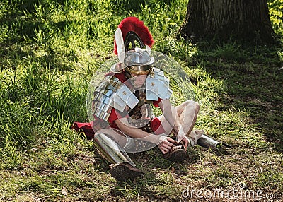 Roman centurion put on his sandals during the Elf Fantasy Fair Editorial Stock Photo