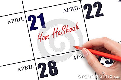 April 21. Hand writing text Yom HaShoah on calendar date. Save the date. Stock Photo