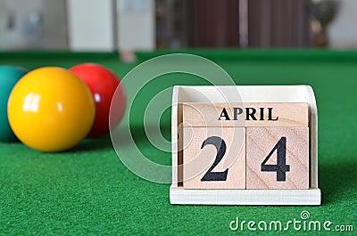April 24, number cube with balls on snooker table, sport background. Stock Photo