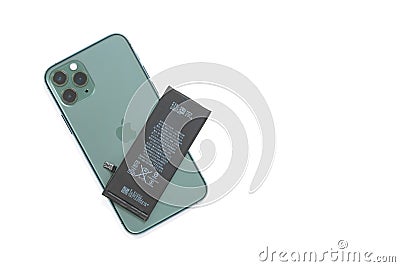 Apple iPhone 11 Pro model midnight green color, with three cameras on the back side and lithium battery above Editorial Stock Photo