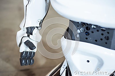 06 april 2019 Russia Novosibirsk: The man assembles a human-like robot and mends his hand Editorial Stock Photo