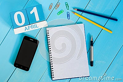 April 1st. Image of april 1 wooden color calendar on blue background. Empty space for text. All Fool`s Day Stock Photo