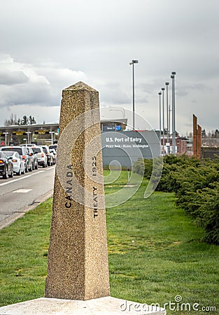 April 14, 2019 - Surrey, British Columbia: Internationl Boundary Monument marker at Canada-USA border. Editorial Stock Photo