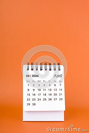 April 2024 table calendar on orange color background Stock Photo