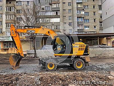 April 24, 2021, Ukraine, Kharkiv, excavator work, road repair Editorial Stock Photo