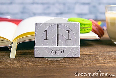 April 11 on the wooden calendar.The eleventh day of the spring month, a calendar for the workplace. Spring Stock Photo